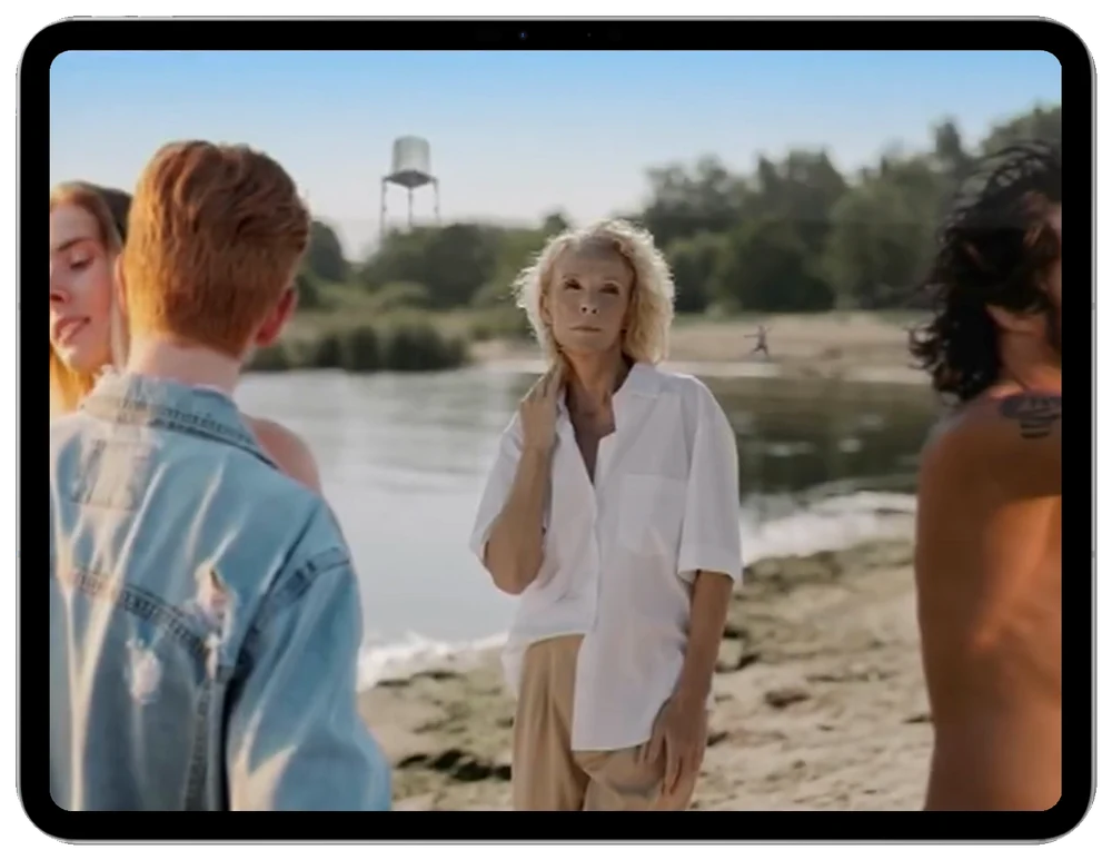 iPad demonstration: unwanted people and objects are marked purple and removed, leaving the main subject beside the water
