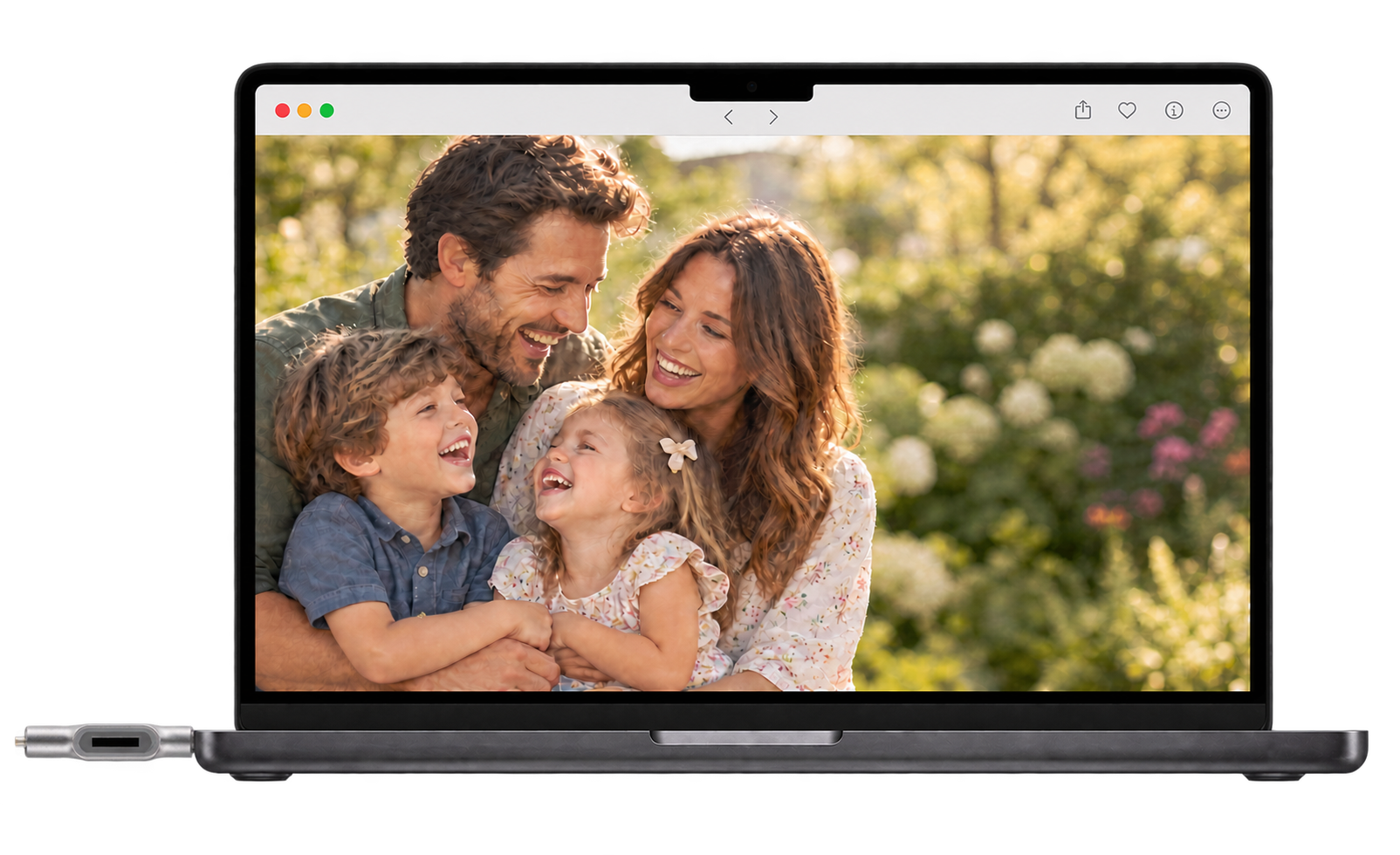 Head-on laptop displaying a family photo with a silver ClickFree drive plugged into its left side